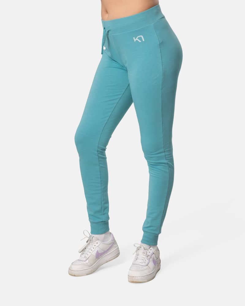 Woman wearing the teal Kari Traa Kari Pants, perfect for a casual day or chilling at home.