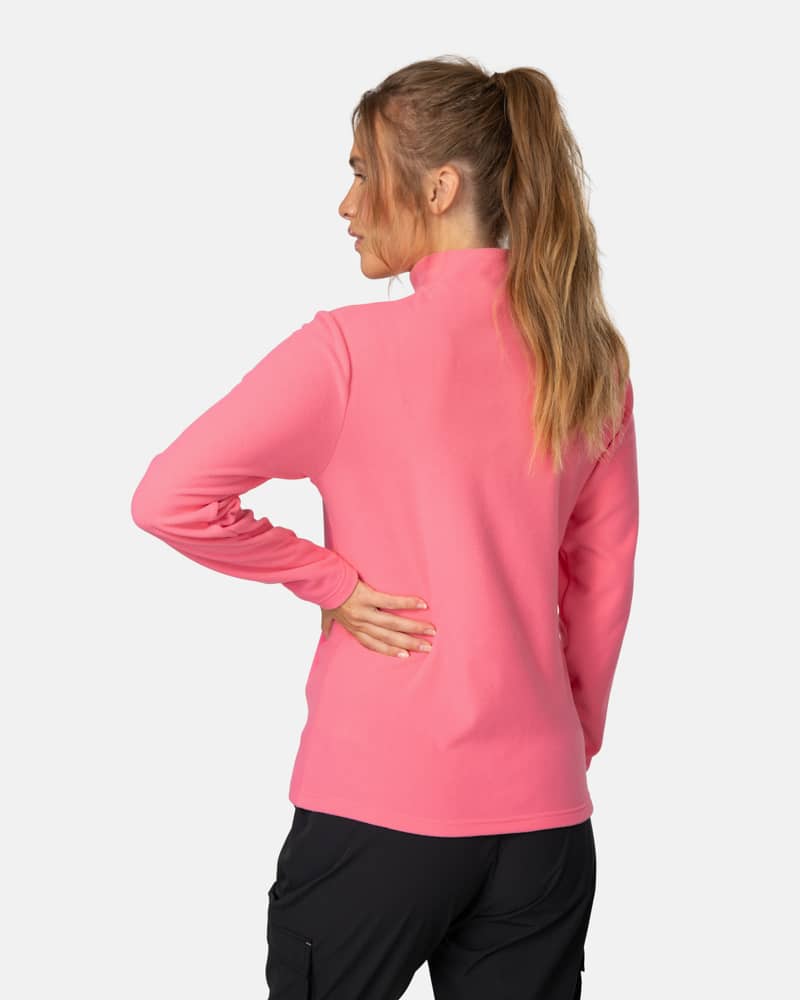 Side view of a woman in the pink Kari Traa Kari Full Zip Fleece, showing the comfortable high collar.
