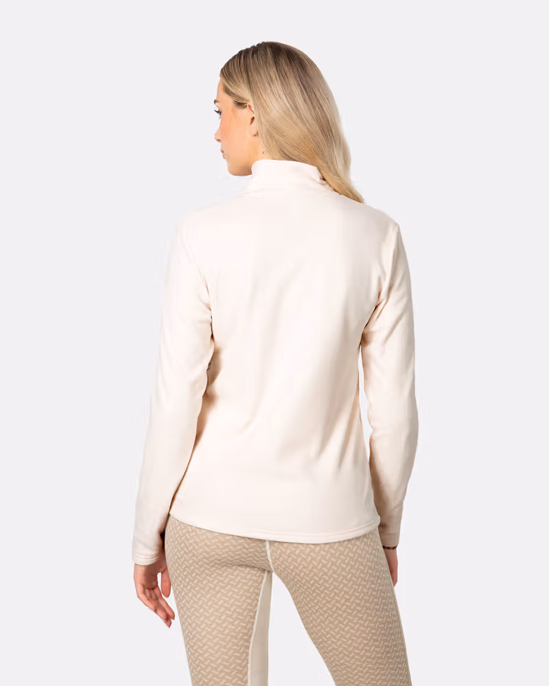 Back view of a woman in the cream Kari Traa Kari Full Zip Fleece, showcasing the regular fit.