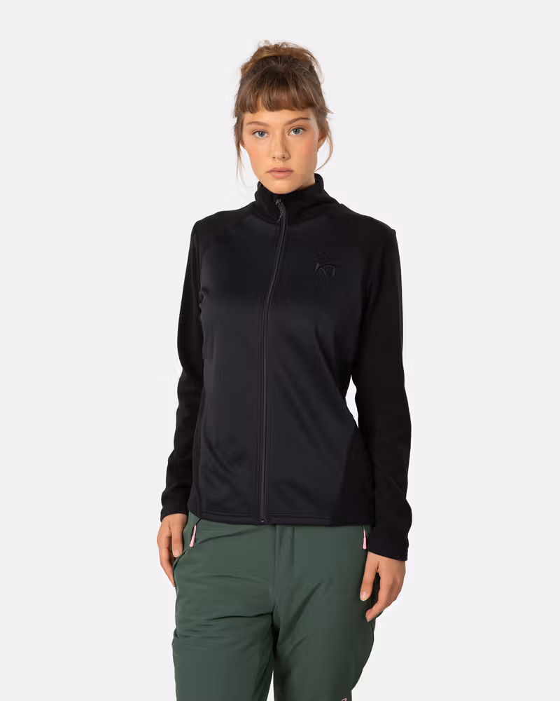 Woman wearing the black Kari Traa Kari Full Zip Fleece, a versatile layer for skiing or cold-weather activities.