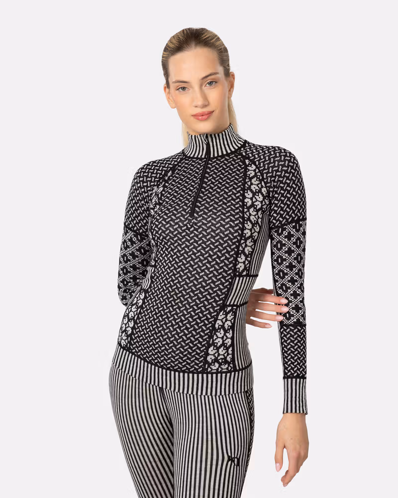 Woman wearing the black Kari Traa Smekker Half Zip with patterned sleeves and a comfortable zip neck.