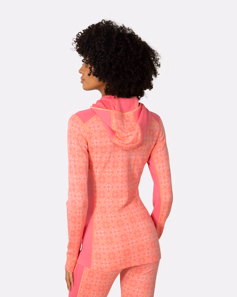 Back view of a woman in the pink Kari Traa Rose Base Layer Hoodie, highlighting the slim, flattering fit and hood.