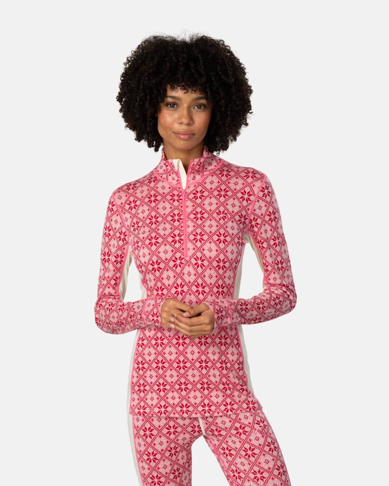 Woman wearing the pink patterned Kari Traa Rose Half Zip top, showing the zip neck and comfortable fit.