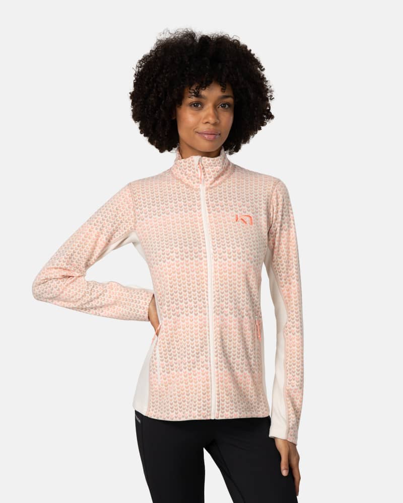 Woman wearing the light pink Kari Traa Olga Fleece, a soft and cozy layer with a high collar and relaxed fit.
