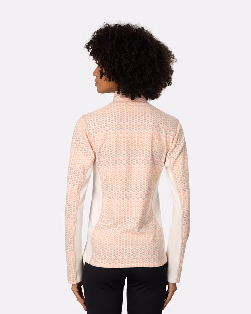 Back view of a woman in the light pink Kari Traa Olga Fleece, showing the comfortable, warming silhouette.