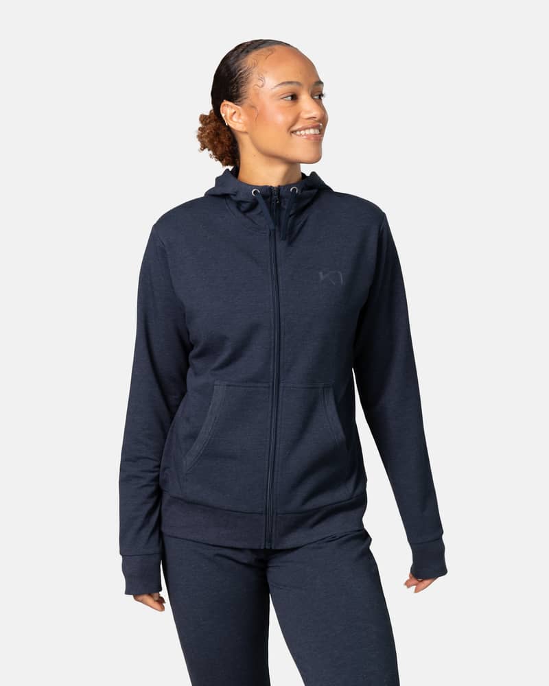 Woman wearing the Kari Traa Kari Hoodie in navy blue, showing its comfortable fit for casual or loungewear.