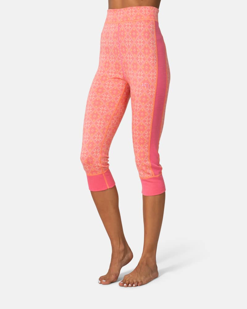Side view of a woman wearing pink Kari Traa Rose High Waist Capri, showing the below-the-knee length.