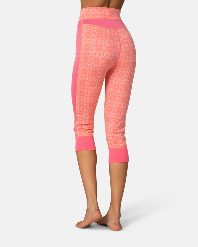 Back view of a woman in pink Kari Traa Rose High Waist Capri, highlighting the warming merino wool fabric.