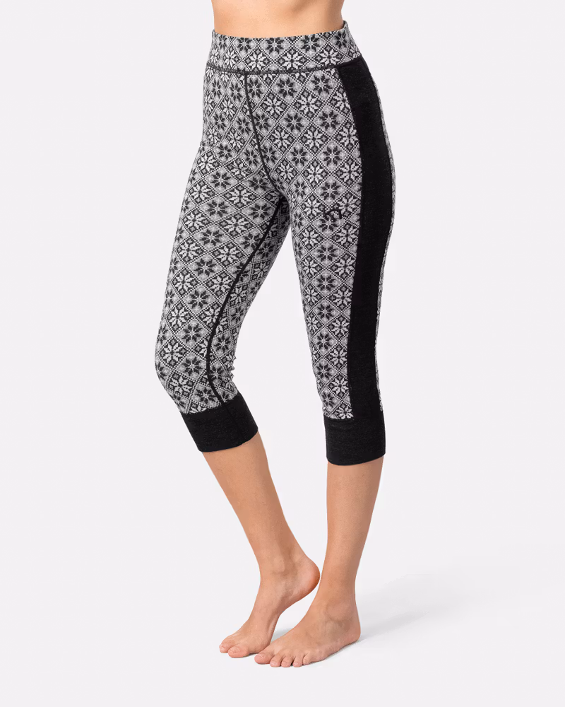 Woman wearing the black Kari Traa Rose High Waist Capri, showing the cropped length and solid black side panel.