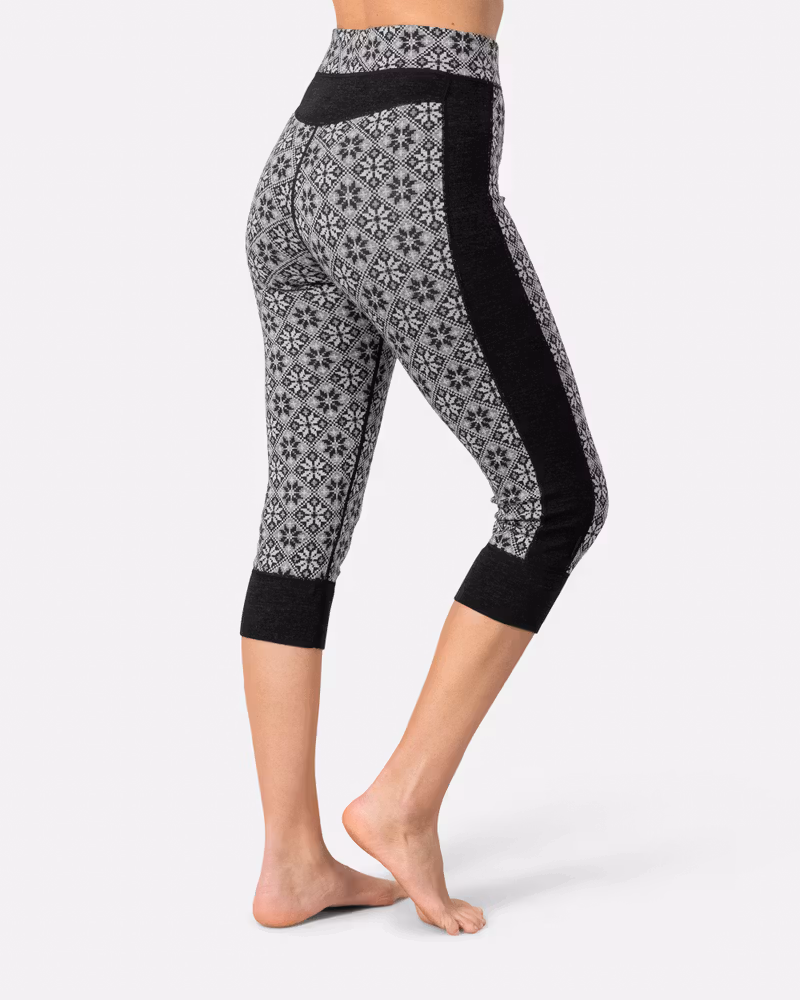 Back view of a woman in the black Kari Traa Rose High Waist Capri, showcasing the slim fit and side panel detail.