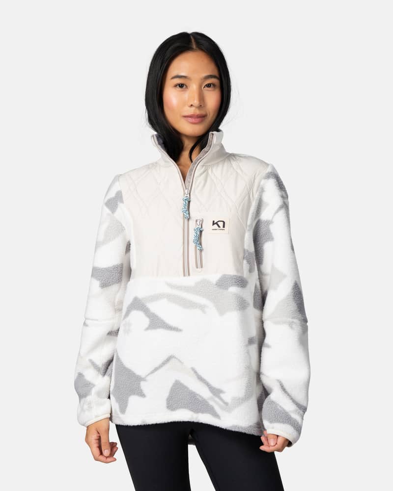 Woman wearing the white camo Kari Traa Røthe Half Zip, showing the regular fit and cozy handfeel.