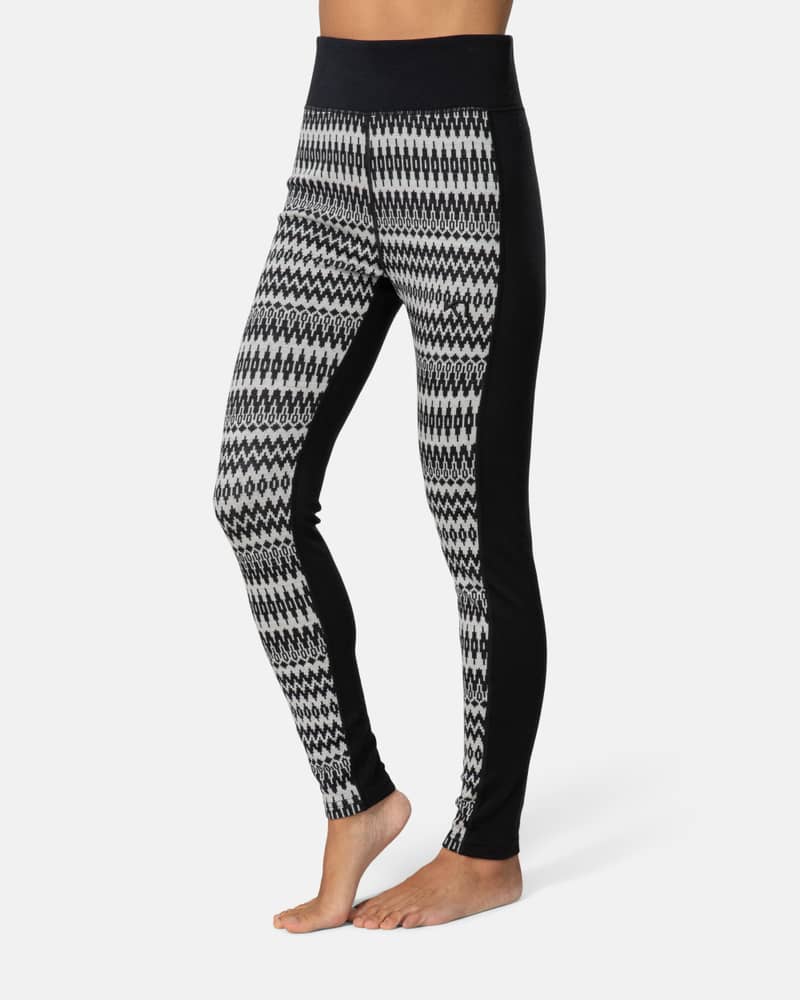 Side view of a woman wearing black Kari Traa Silja 2.0 Pants with a white and grey Scandinavian pattern.