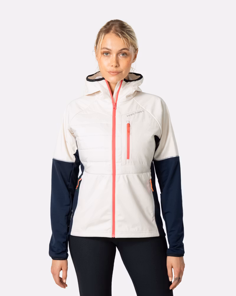 Woman wearing the Kari Traa Nia hooded jacket in off-white and navy, with a contrasting red zipper, perfect for running.