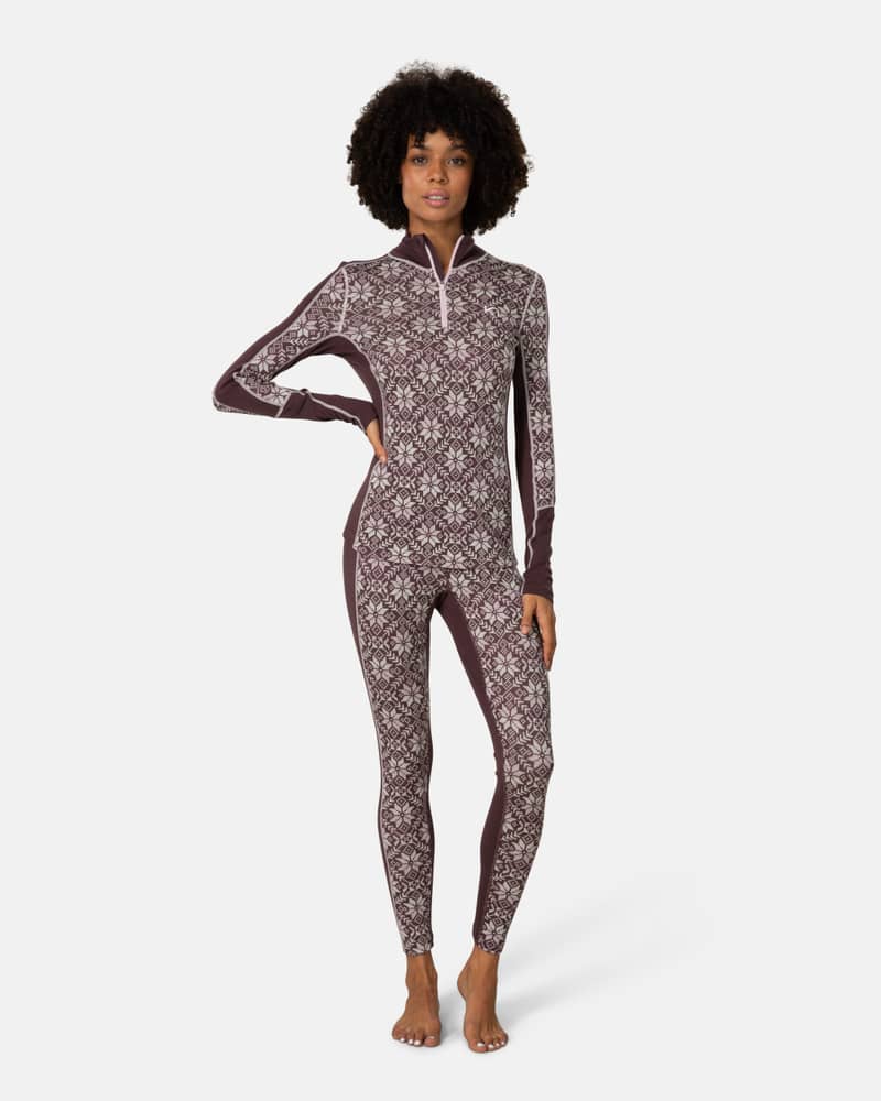 Woman wearing Kari Traa Anna Half Zip in dark red with Nordic print, merino wool base layer, full body shot