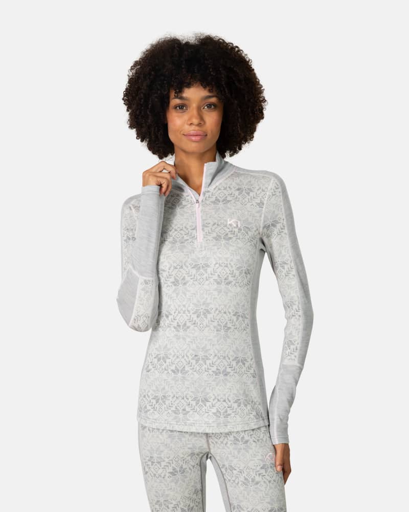 Front view of woman in Kari Traa Anna Half Zip grey melange merino wool base layer, Nordic snowflake print