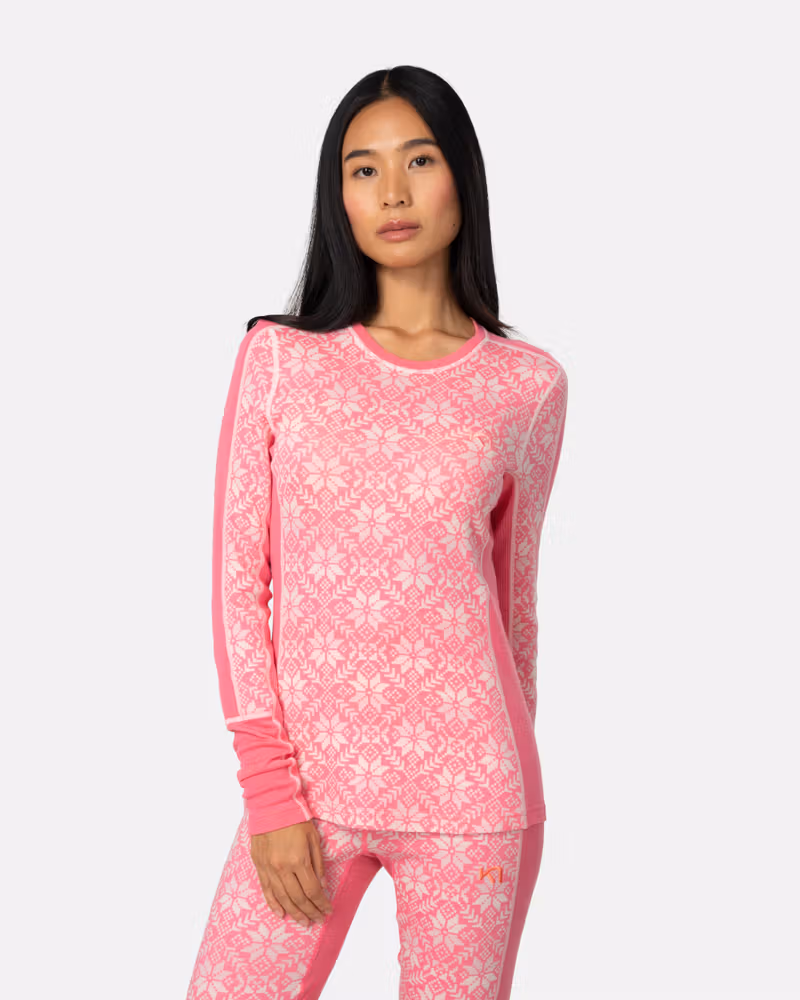 Woman wearing the bright pink Kari Traa Anna Long Sleeve, showcasing the slim fit and round neck design.