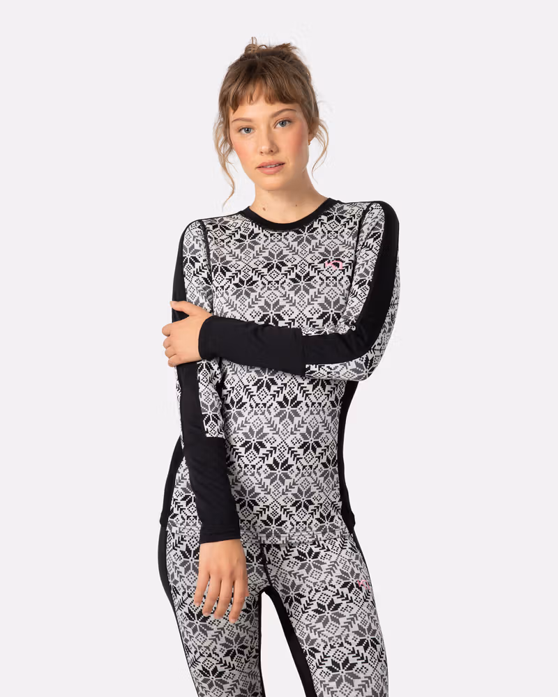 Woman wearing the black Kari Traa Anna Long Sleeve with a grey and white Nordic print for a bold look.