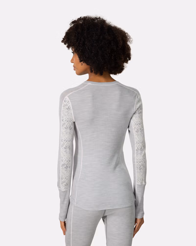 Back view of a woman in the grey Kari Traa Anna Long Sleeve, showcasing the slim fit and raglan sleeves.