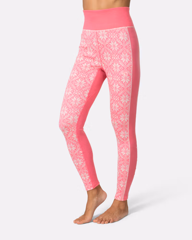 Side view of a woman in pink Kari Traa Anna High Waist Pants, showcasing the Nordic pattern.