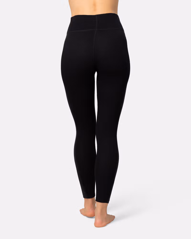 Back view of a woman in black Kari Traa Anna High Waist Pants, showcasing the high-waist fit.