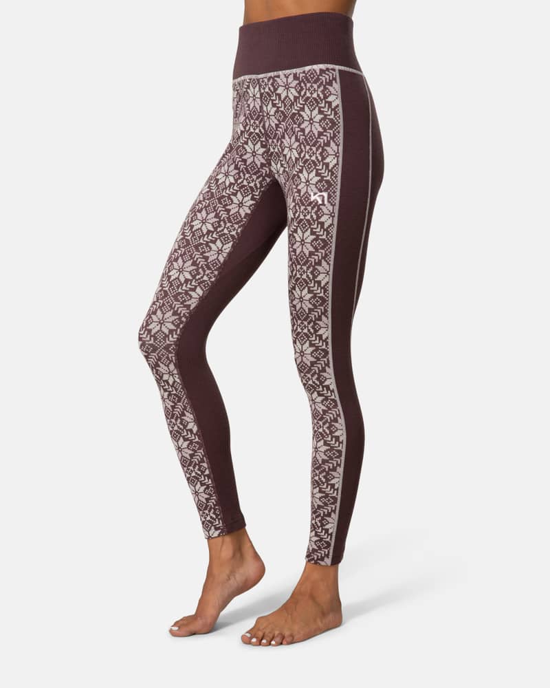 Side view of a woman in dusty rose Kari Traa Anna High Waist Pants, showing the Nordic print.