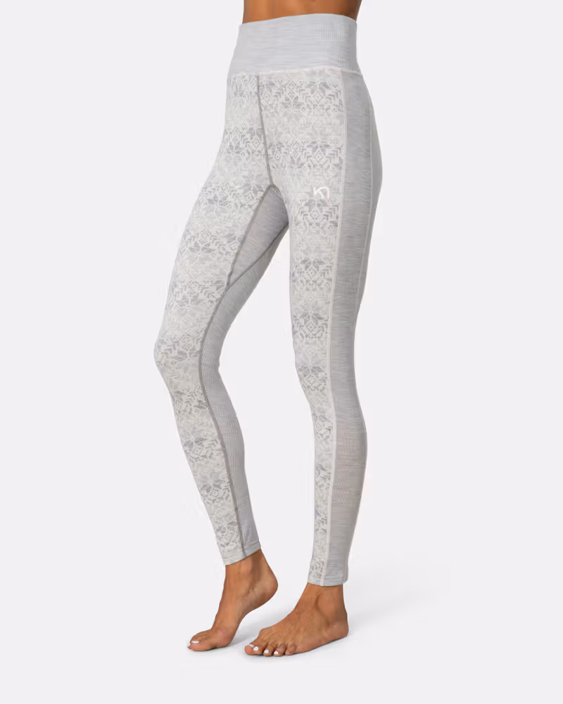 Side view of a woman in grey Kari Traa Anna High Waist Pants with a white Nordic print.