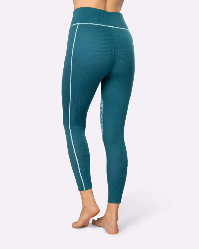 Back view of a woman in teal Kari Traa Anna High Waist Pants, highlighting the slim, flattering fit.