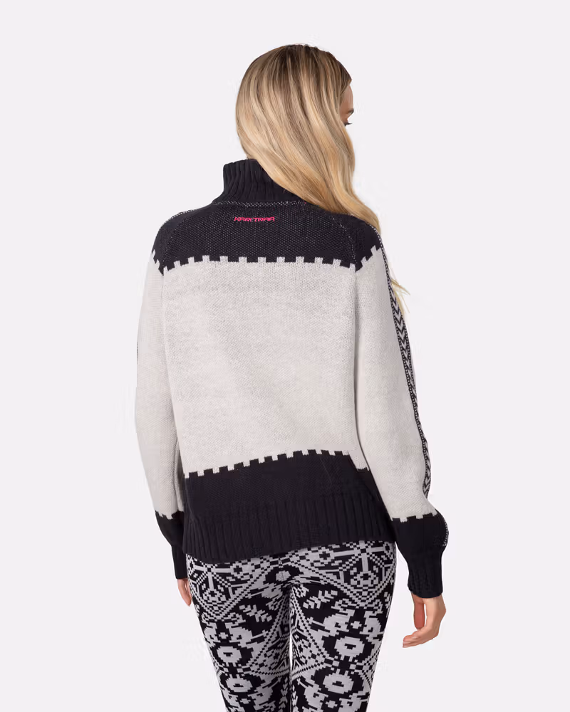 Back view of a woman in the black and white Kari Traa Saga Knit, highlighting the loose fit and color blocking.