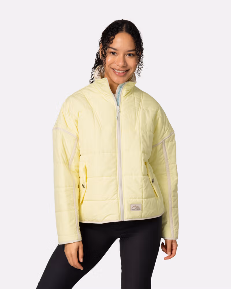 Woman wearing the Kari Traa Mina Jacket in light yellow, a cozy, quilted layering piece for chilly days.