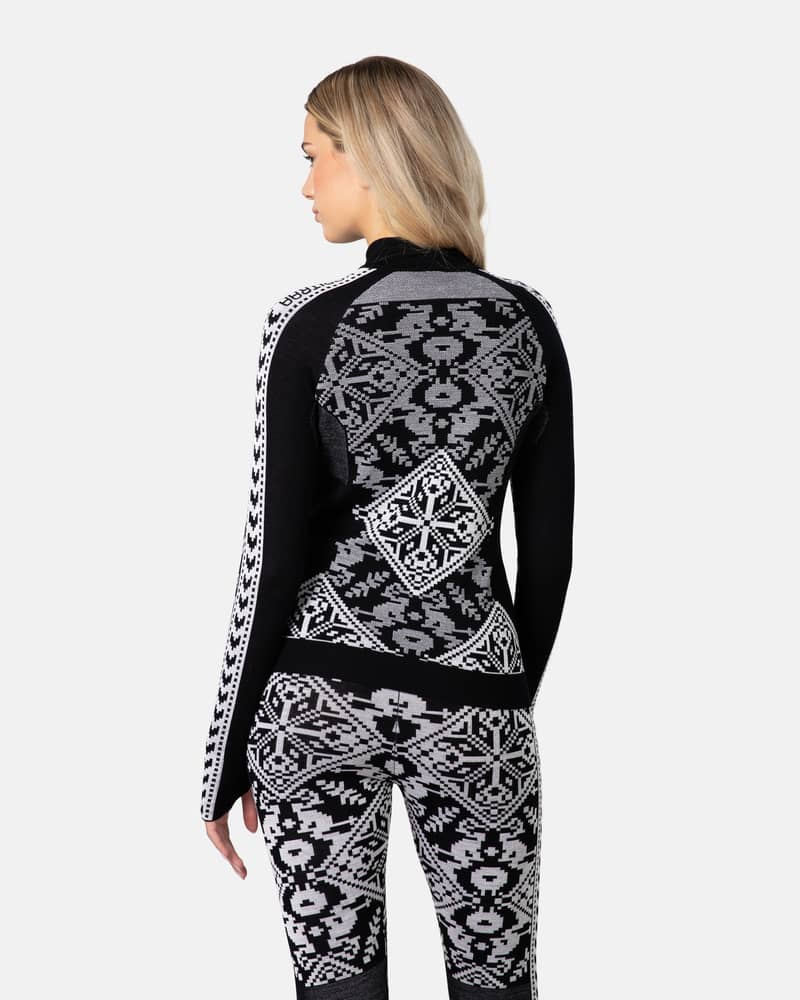 Back view of a woman in the black Kari Traa Saga Half Zip, showing the detailed jacquard knit.