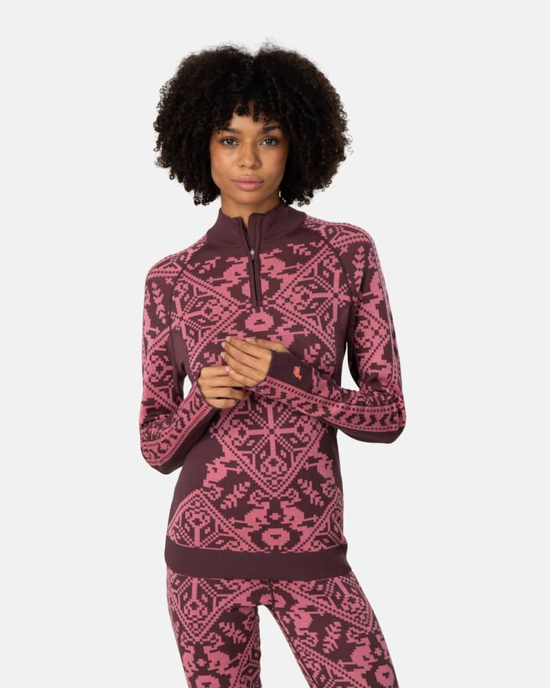 Woman wearing the maroon Kari Traa Saga Half Zip, showcasing the bold Nordic-inspired knit pattern.
