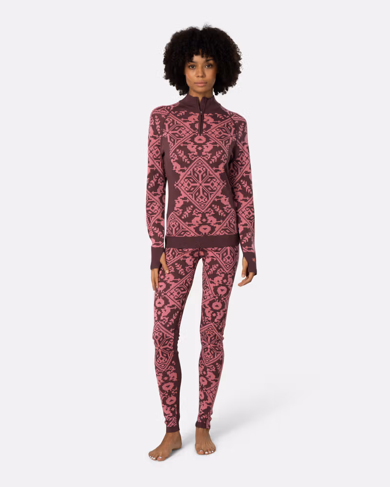 Woman wearing the complete maroon Kari Traa Saga baselayer set for superior warmth and unrestricted movement.