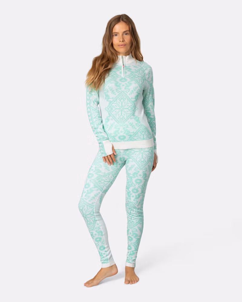 Woman styled in the complete mint green Kari Traa Saga baselayer set for a showstopping winter look.