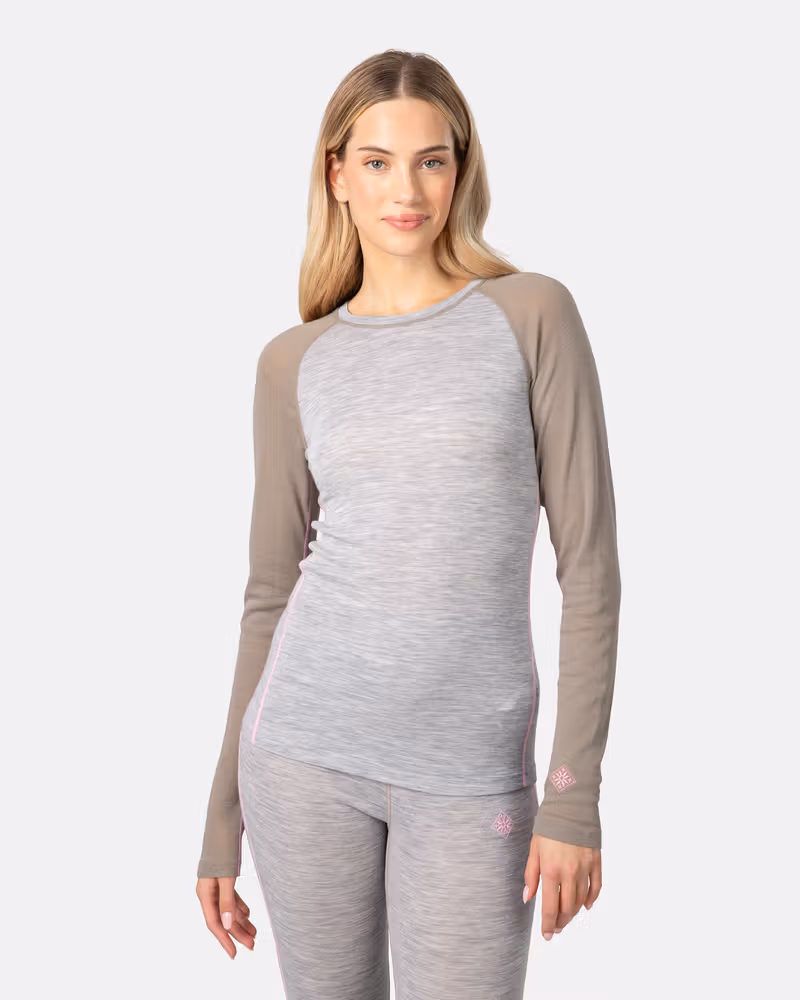 Side profile of a woman wearing the Kari Traa Kaia Set in grey, showing the complete base layer outfit.