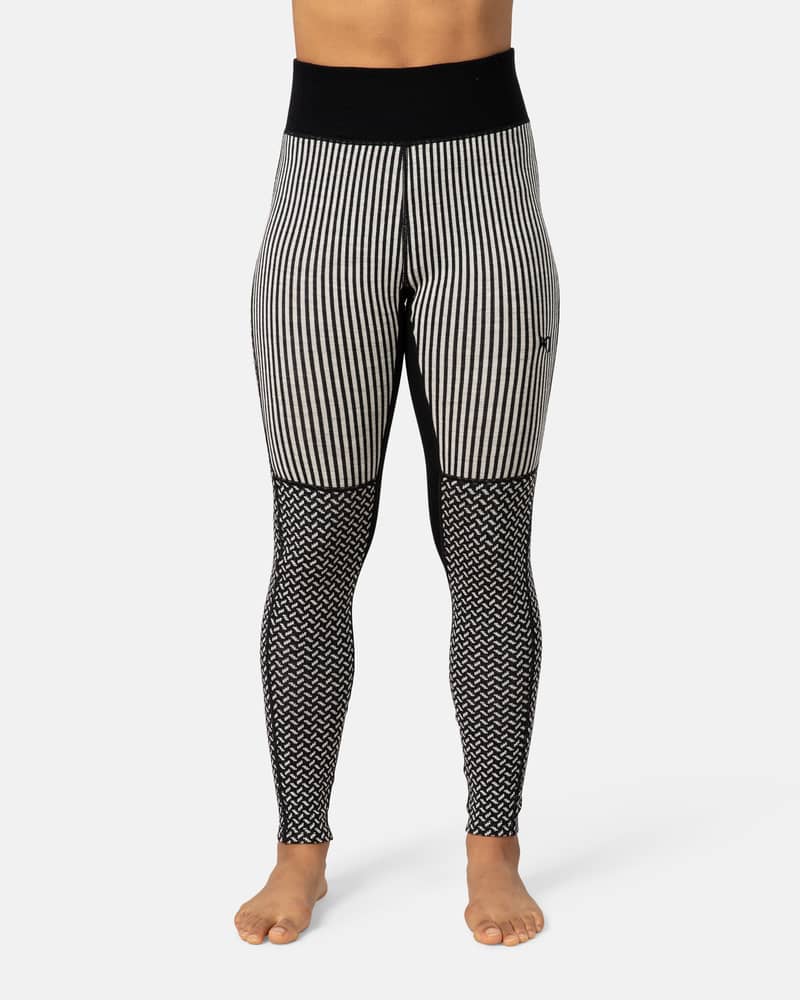 Woman wearing black Kari Traa Smekker High Waist Pants with patterned panels for a stylish layered look.