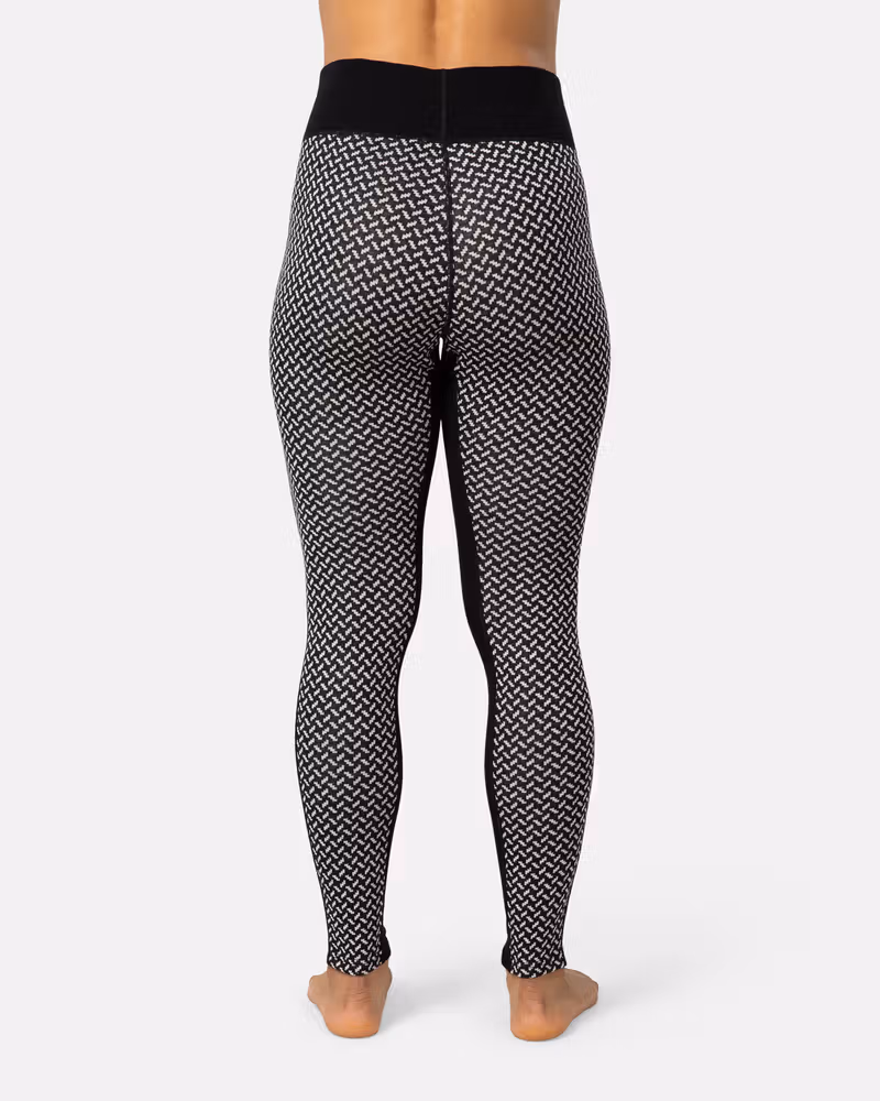 Back view of a woman in black Kari Traa Smekker High Waist Pants, showing the high-waist coverage.