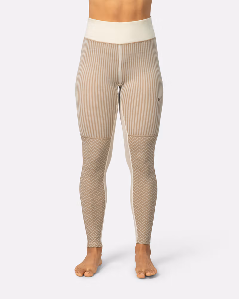 Front view of a woman wearing beige Kari Traa Smekker High Waist Pants, highlighting the flattering fit.