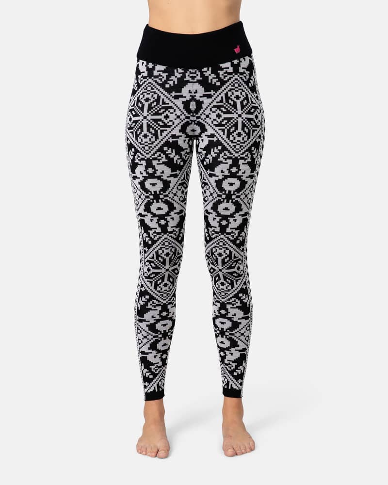 Side view of a woman in black Kari Traa Saga Base Layer Pants with a white Nordic pattern.