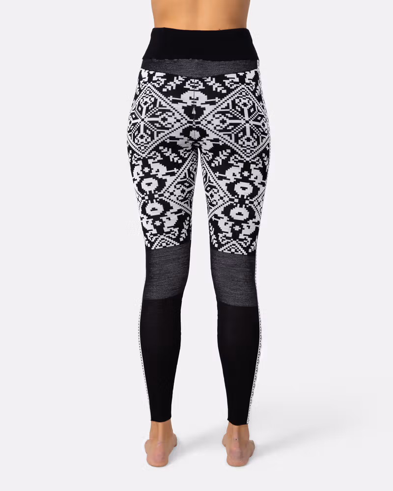 Back view of a woman in black Kari Traa Saga Base Layer Pants, showing the high-waist coverage.