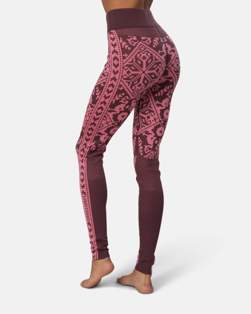 Back view of a woman in maroon Kari Traa Saga Base Layer Pants, highlighting the seamless construction.