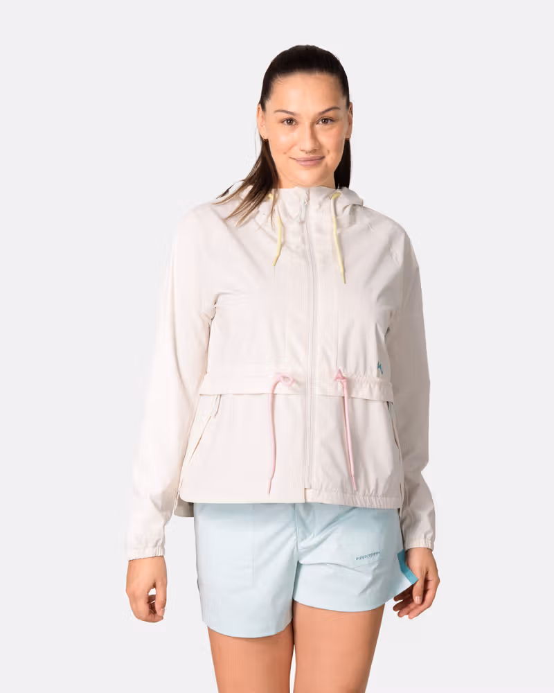Woman wearing the Kari Traa Luna Jacket in off-white, a weatherproof layer with colorful details and an adjustable hood.