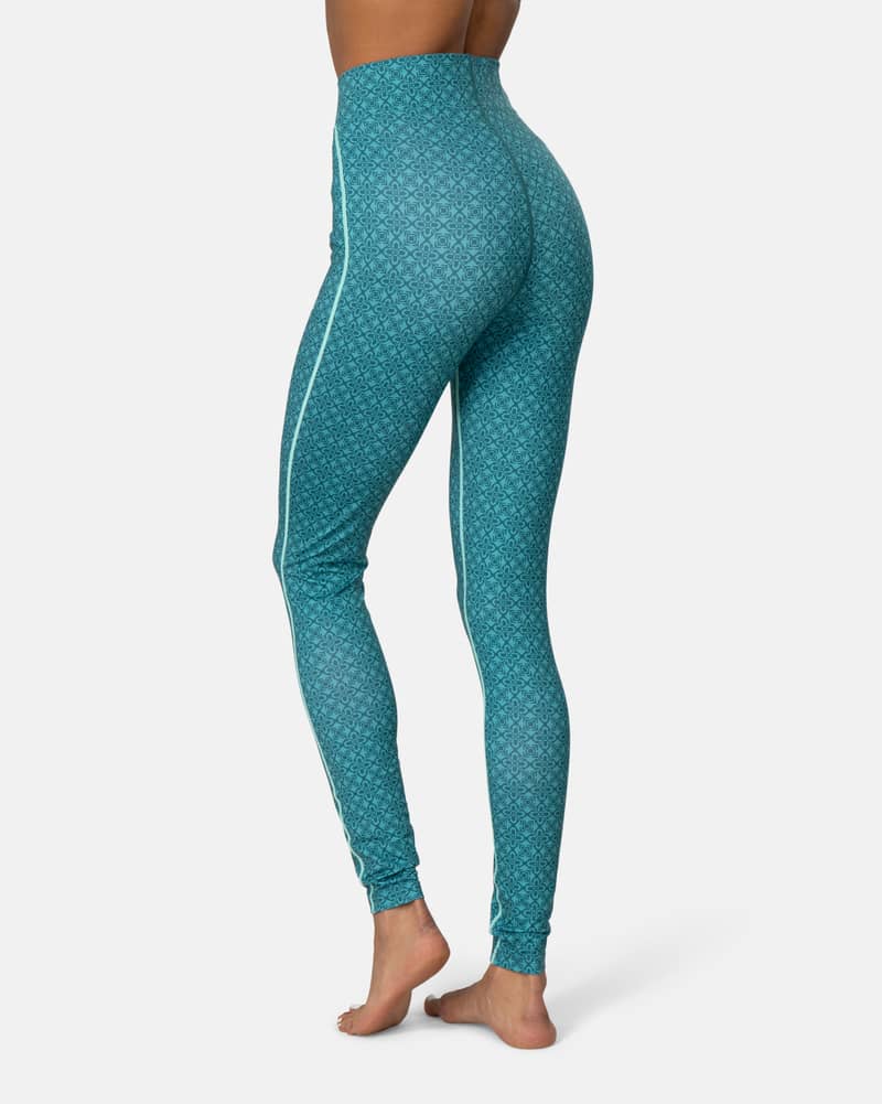 Back view of a woman in teal Kari Traa Fryd High Waist Pants, highlighting the flattering high waistband.