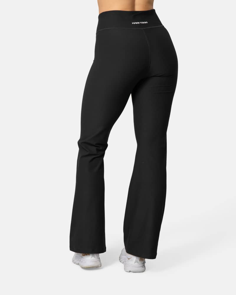 Back view of the Kari Traa Nina Flare Tights in black, highlighting the slim fit and flared leg silhouette.