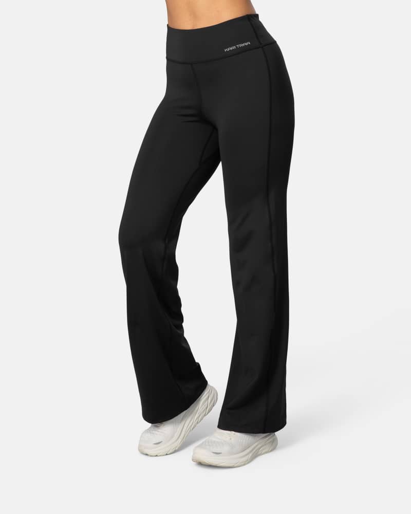 Woman wearing the black Kari Traa Ava Bootcut Tights, showing the 4-way stretch fabric and flattering slim fit.