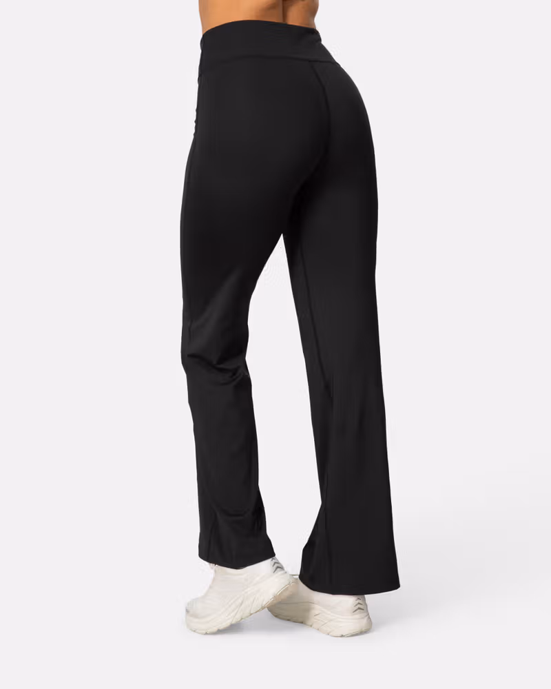 Back view of the black Kari Traa Ava Bootcut Tights, highlighting the wide waistband for comfort and coverage.