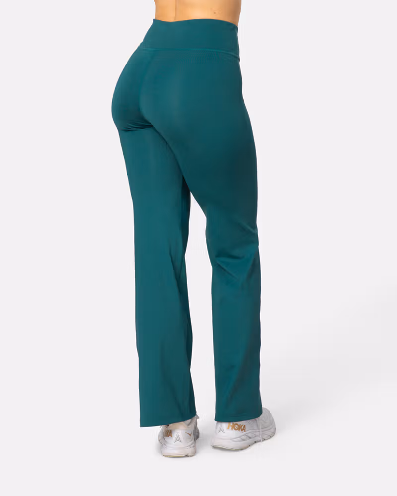 Back view of the peacock Kari Traa Ava Bootcut Tights, highlighting the wide waistband for comfort and coverage.