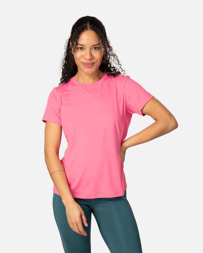 Woman wearing the bubblegum pink Kari Traa Ava Tee, a performance top with a flattering round neck and regular fit.