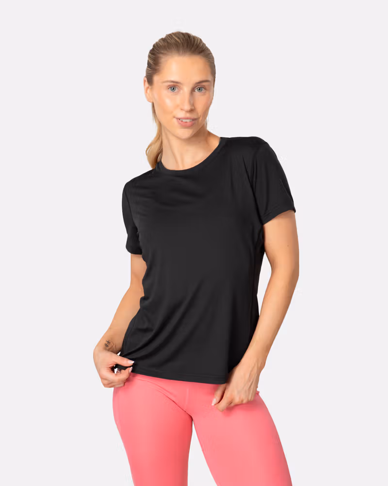 Woman wearing the black Kari Traa Ava Tee, a performance top with a flattering round neck and regular fit.
