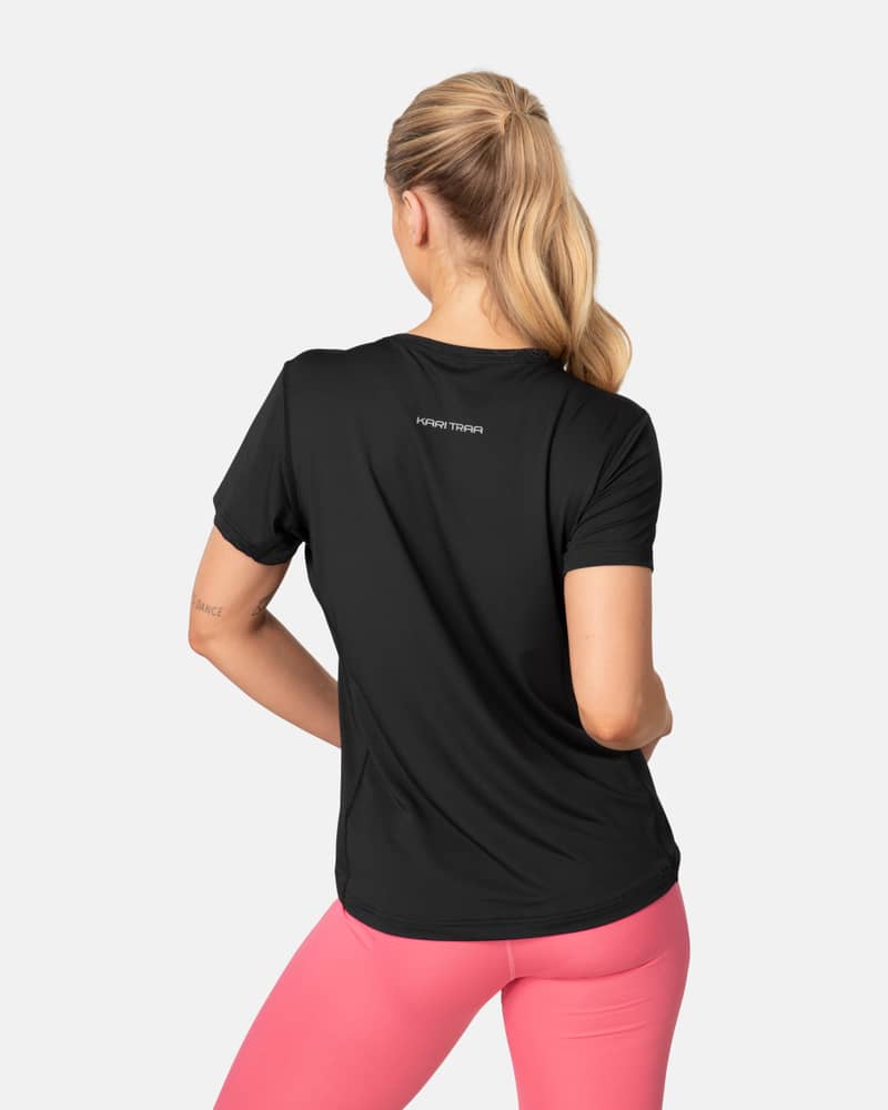 Back view of the black Kari Traa Ava Tee, showing its curved hem and reflective logo for visibility.