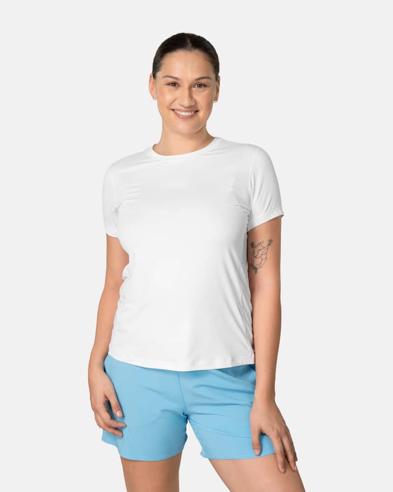 Woman wearing the white Kari Traa Ava Tee, a performance top with a flattering round neck and regular fit.